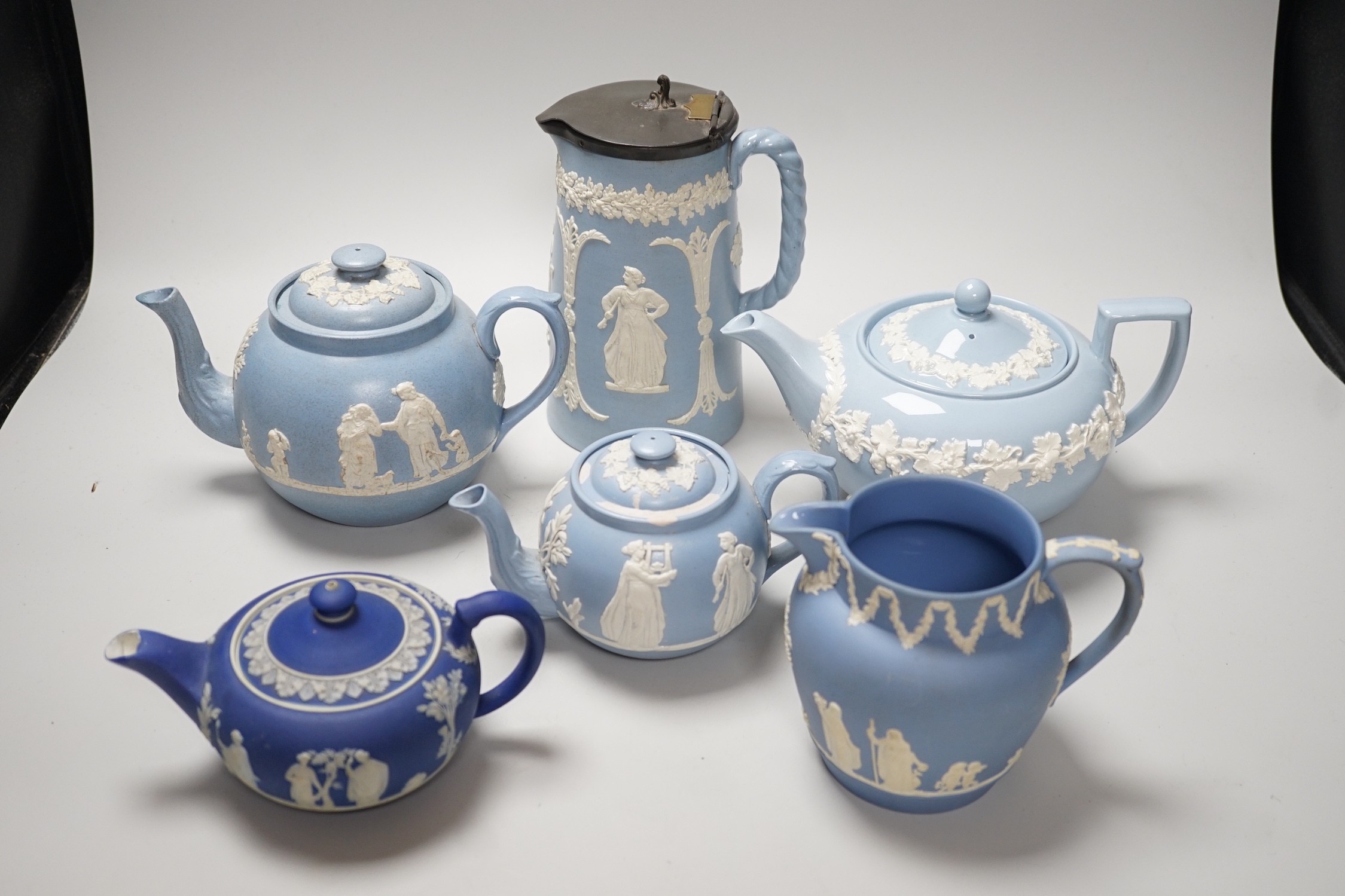 A group of Wedgwood and Wedgwood-style jasperware teapots and jugs.